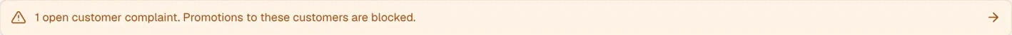 An alert bar: 1 open customer complaint. Promotions to these customers are blocked.